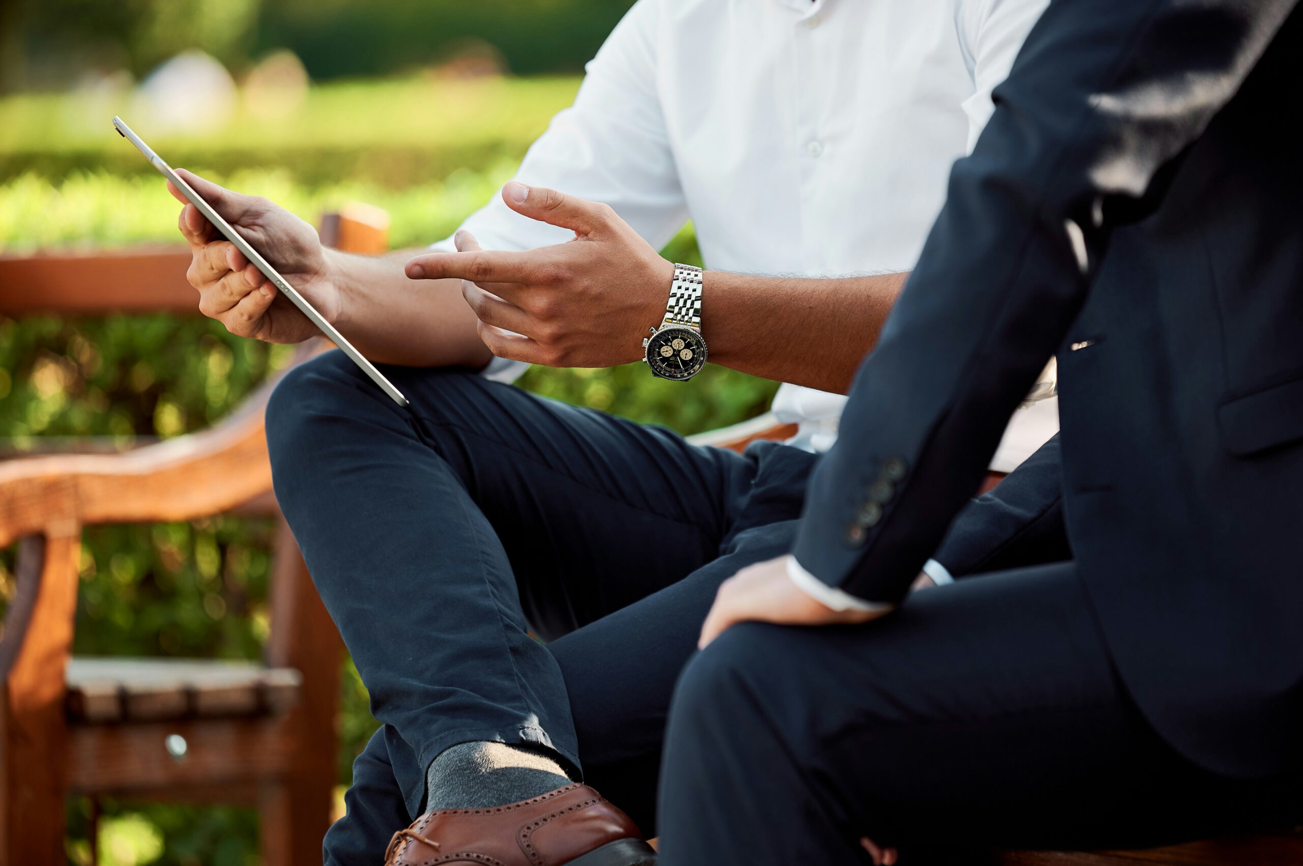 Two business men looking at a tablet, representing the business law team at EKB law firm in Vancouver, advising on commercial lending and financing