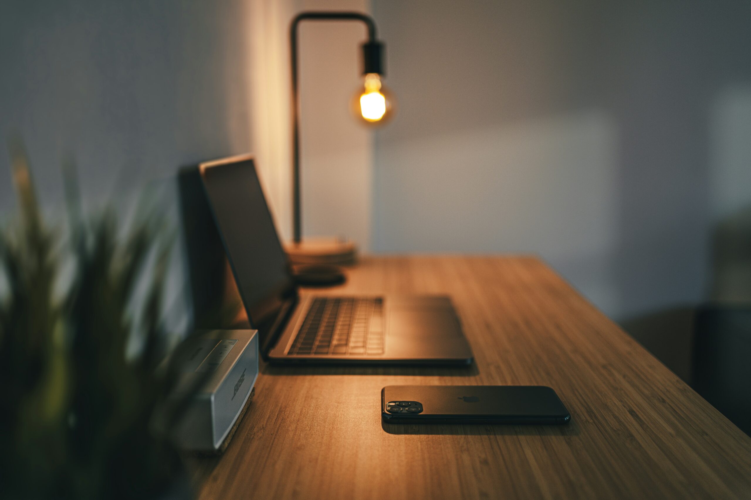 A laptop open under a warm glowing light on a desk, representing employment law matters, LTD issues, retirement concerns and WorkSafe BC cases, as assisted by the employment lawyers at EKB in Vancouver